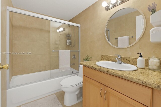 677 NE 24th St Unit 504, Miami, FL 33137 - full bath featuring vanity, shower / bath combination with glass door, tile walls, and tile patterned flooring