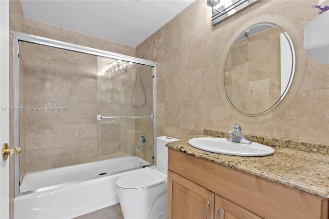 677 NE 24th St Unit 504, Miami, FL 33137 - full bath featuring tile walls, vanity, and combined bath / shower with glass door