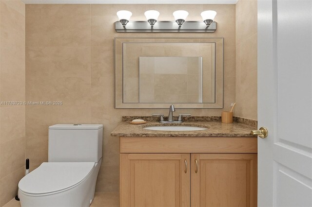 677 NE 24th St Unit 504, Miami, FL 33137 - half bathroom featuring vanity and tile walls