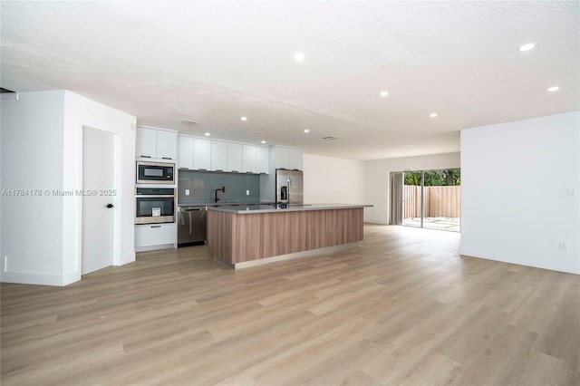 13912 SW 103rd Ln, Miami, FL 33186 - kitchen featuring recessed lighting, open floor plan, a center island with sink, and appliances with stainless steel finishes