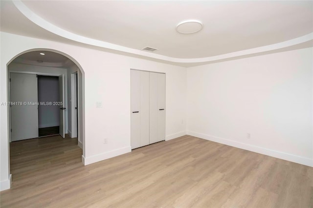 13912 SW 103rd Ln, Miami, FL 33186 - unfurnished bedroom with arched walkways, light wood finished floors, visible vents, and baseboards
