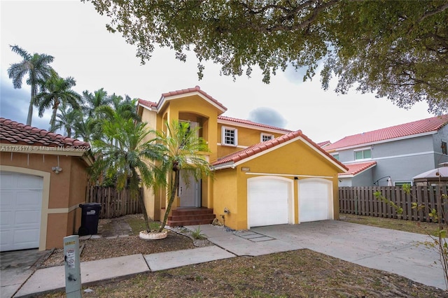 13912 SW 103rd Ln, Miami, FL 33186 - mediterranean / spanish house featuring stucco siding, driveway, a tile roof, a garage, and fence
