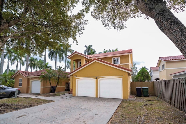 13912 SW 103rd Ln, Miami, FL 33186 - mediterranean / spanish-style house with a garage, a tile roof, fence, concrete driveway, and stucco siding