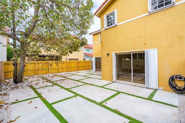 13912 SW 103rd Ln, Miami, FL 33186 - exterior space featuring a patio area, a tiled roof, fence, and stucco siding