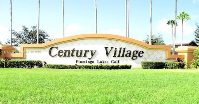 community sign featuring a yard