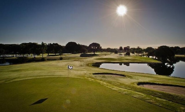 view of home's community with a water view and golf course view