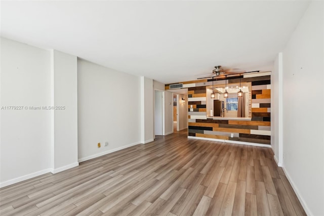 101 Royal Park Dr Unit 1D, Oakland Park, FL 33309 - unfurnished living room featuring visible vents, baseboards, and wood finished floors