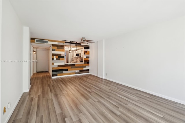 101 Royal Park Dr Unit 1D, Oakland Park, FL 33309 - unfurnished room with visible vents, baseboards, wood finished floors, and stairs