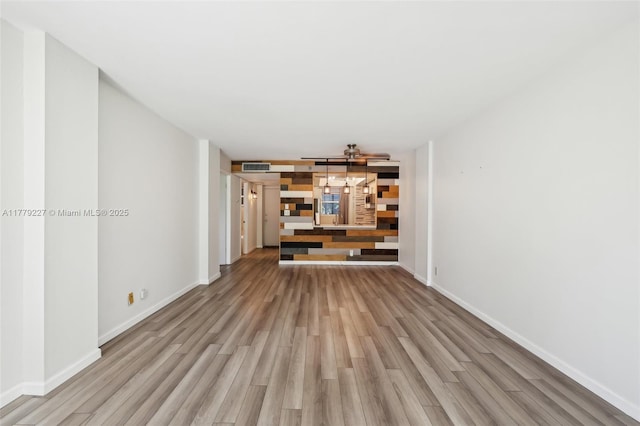 101 Royal Park Dr Unit 1D, Oakland Park, FL 33309 - unfurnished living room featuring visible vents, baseboards, and light wood-style floors