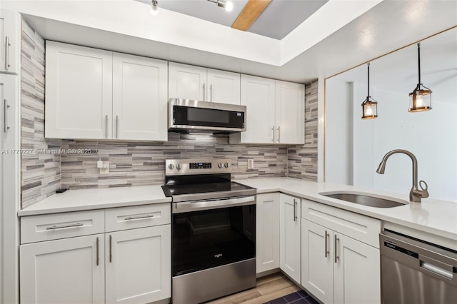 101 Royal Park Dr Unit 1D, Oakland Park, FL 33309 - kitchen with light countertops, white cabinetry, backsplash, appliances with stainless steel finishes, and a sink