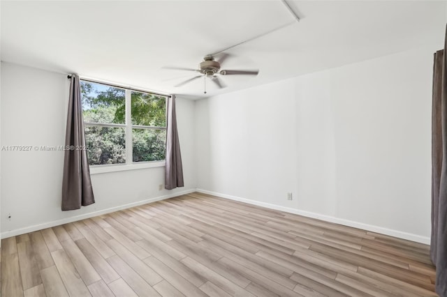101 Royal Park Dr Unit 1D, Oakland Park, FL 33309 - spare room featuring light wood-style floors, baseboards, and a ceiling fan