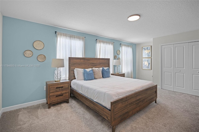 690 Drop, Shot, FL 33896 - bedroom with a textured ceiling, a closet, carpet flooring, and baseboards