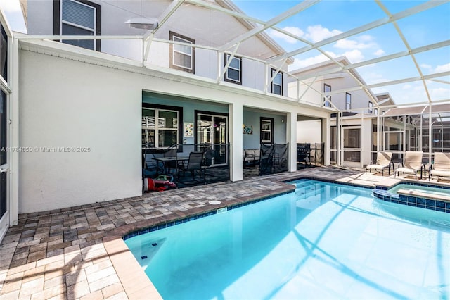 690 Drop, Shot, FL 33896 - view of swimming pool featuring a patio area, a pool with connected hot tub, and a lanai