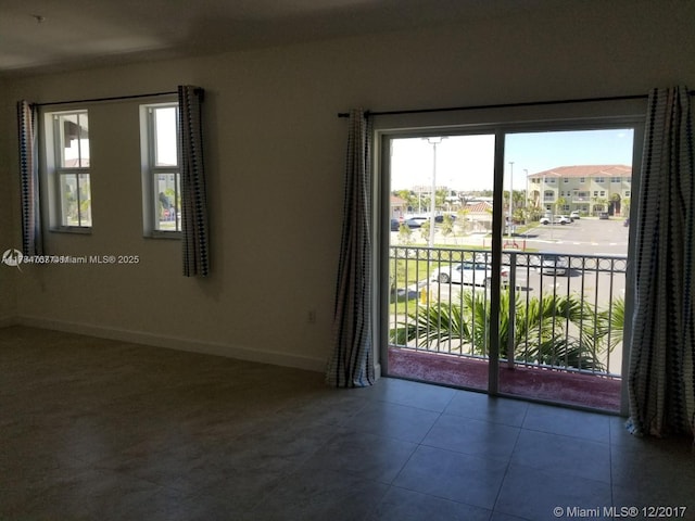 290 NW 109th Ave Unit 216, Miami, FL 33172 - spare room with tile patterned floors and baseboards