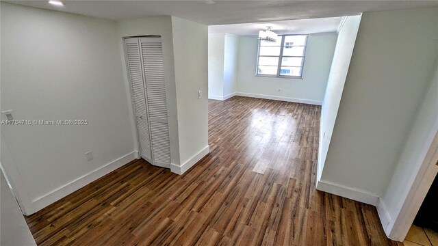 300 Bayview Dr Unit 206, Sunny Isles Beach, FL 33160 - spare room featuring a chandelier, baseboards, and dark wood finished floors