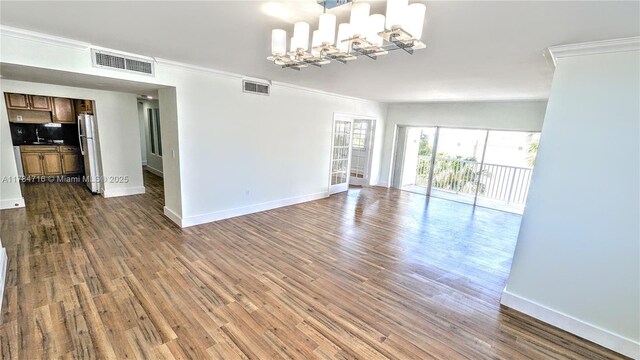 300 Bayview Dr Unit 206, Sunny Isles Beach, FL 33160 - unfurnished living room with crown molding, baseboards, and dark wood-type flooring