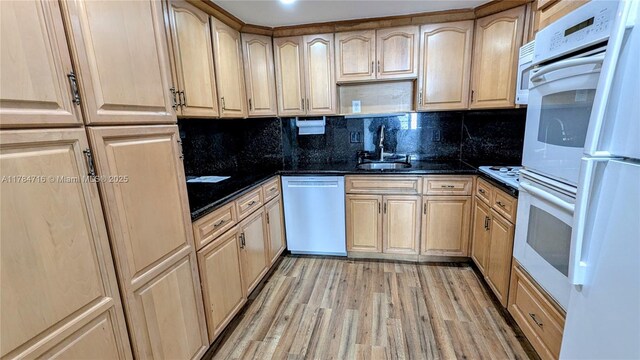300 Bayview Dr Unit 206, Sunny Isles Beach, FL 33160 - kitchen with white appliances, a sink, light brown cabinetry, light wood finished floors, and tasteful backsplash