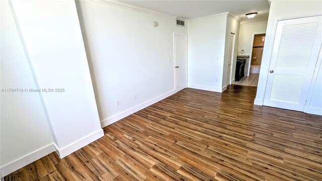 300 Bayview Dr Unit 206, Sunny Isles Beach, FL 33160 - unfurnished room with crown molding, wood finished floors, and baseboards