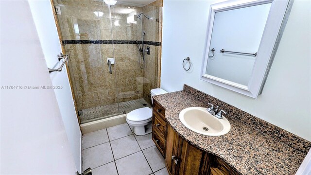 300 Bayview Dr Unit 206, Sunny Isles Beach, FL 33160 - full bathroom featuring toilet, a shower stall, tile patterned flooring, and vanity