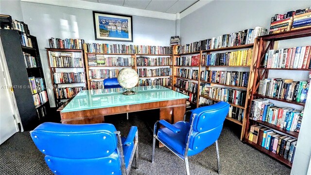 300 Bayview Dr Unit 206, Sunny Isles Beach, FL 33160 - carpeted home office featuring wall of books