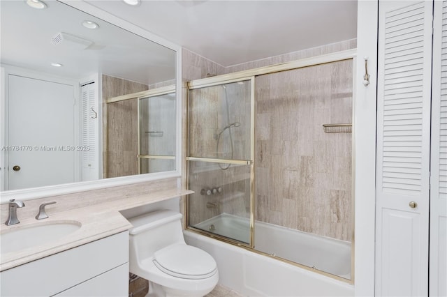 full bathroom featuring visible vents, a closet, enclosed tub / shower combo, and vanity