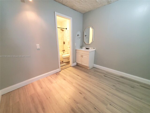 16750 NE 10th Ave Unit 326, North Miami Beach, FL 33162 - bathroom featuring wood finished floors, vanity, and baseboards