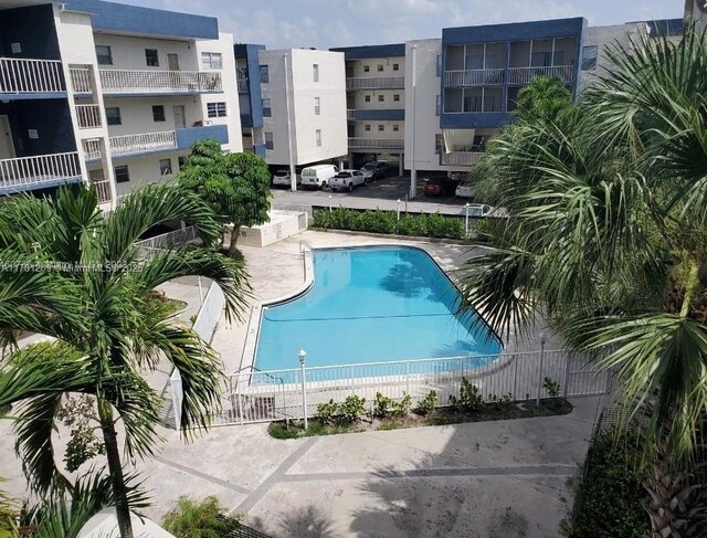 16750 NE 10th Ave Unit 326, North Miami Beach, FL 33162 - bathroom with shower / bathtub combination, toilet, and tile walls