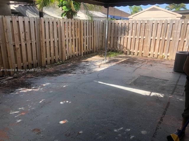 view of patio with fence and cooling unit