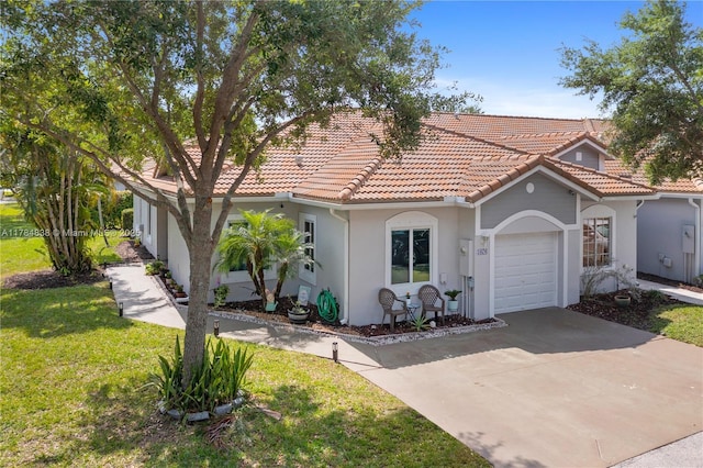 mediterranean / spanish-style house with a garage, stucco siding, a front yard, a tile roof, and driveway