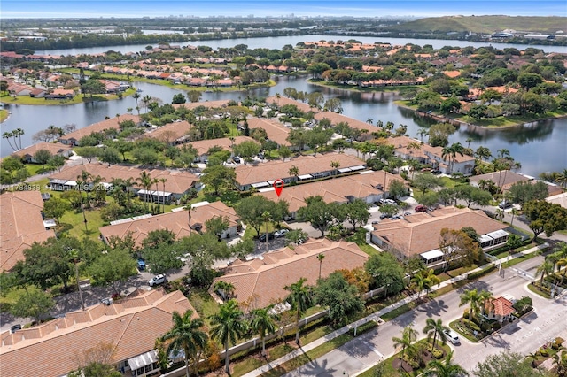 drone / aerial view with a residential view and a water view