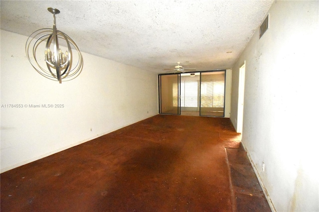 spare room featuring concrete floors, visible vents, ceiling fan with notable chandelier, and a textured ceiling