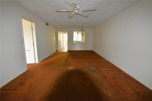 spare room with ceiling fan with notable chandelier