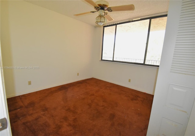 empty room featuring ceiling fan, baseboards, and carpet floors