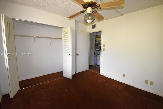 unfurnished bedroom with a closet, ceiling fan, visible vents, and concrete floors