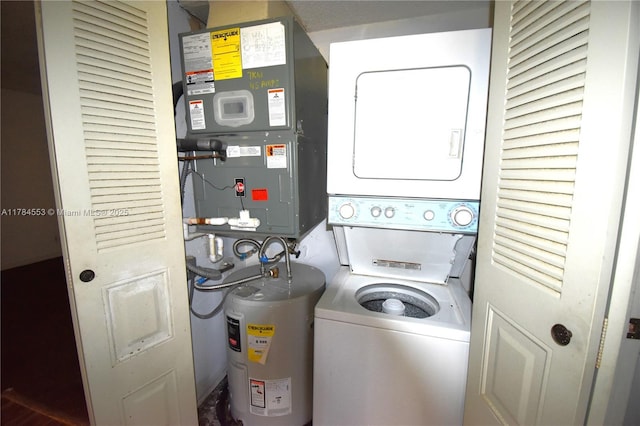 clothes washing area featuring water heater, stacked washer and dryer, and laundry area