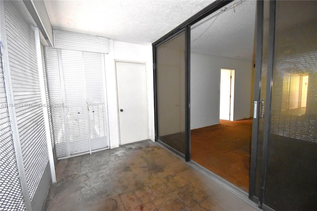 hall featuring concrete flooring