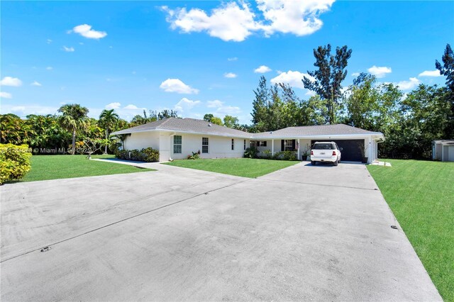 17746 48th Ct N, Loxahatchee, FL 33470 - ranch-style home with a front yard, concrete driveway, and a garage