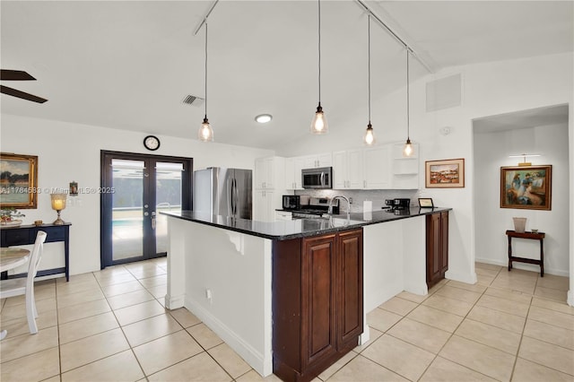 17746 48th Ct N, Loxahatchee, FL 33470 - kitchen with appliances with stainless steel finishes, track lighting, lofted ceiling, light tile patterned floors, and backsplash