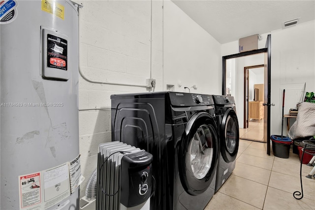 17746 48th Ct N, Loxahatchee, FL 33470 - laundry room with water heater, independent washer and dryer, light tile patterned flooring, and concrete block wall