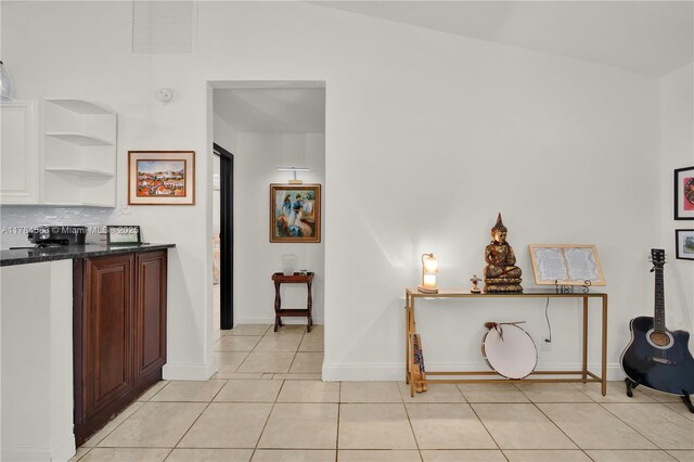 17746 48th Ct N, Loxahatchee, FL 33470 - kitchen featuring light tile patterned floors, tasteful backsplash, open shelves, and dark stone countertops