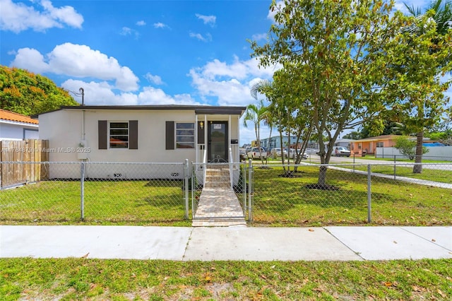 301 E 35th St, Hialeah, FL 33013 - view of front of home featuring a front yard, a gate, and a fenced front yard