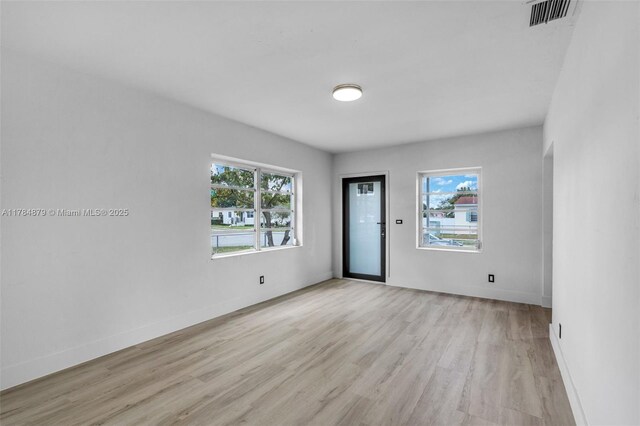 301 E 35th St, Hialeah, FL 33013 - unfurnished room featuring visible vents, baseboards, light wood-type flooring, and plenty of natural light