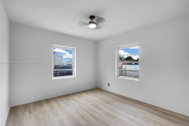 301 E 35th St, Hialeah, FL 33013 - empty room with plenty of natural light, a ceiling fan, and wood finished floors