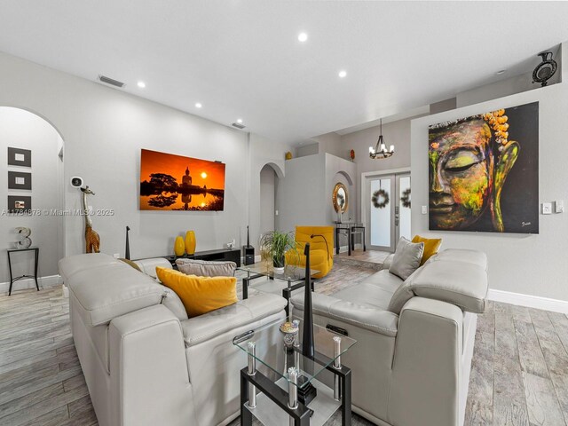 2021 SE 17th Ave, Homestead, FL 33035 - living room featuring arched walkways, wood finished floors, recessed lighting, baseboards, and a chandelier