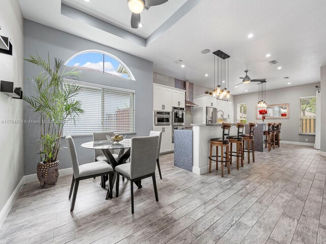 2021 SE 17th Ave, Homestead, FL 33035 - dining space with a ceiling fan, recessed lighting, light wood-style floors, baseboards, and a chandelier