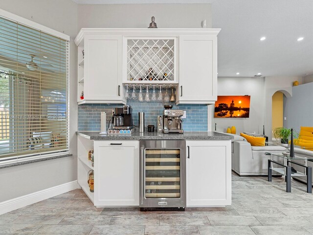 2021 SE 17th Ave, Homestead, FL 33035 - indoor wet bar with wine cooler, tasteful backsplash, baseboards, arched walkways, and recessed lighting