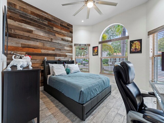 2021 SE 17th Ave, Homestead, FL 33035 - bedroom with wooden walls, recessed lighting, an office area, light wood-style floors, and baseboards