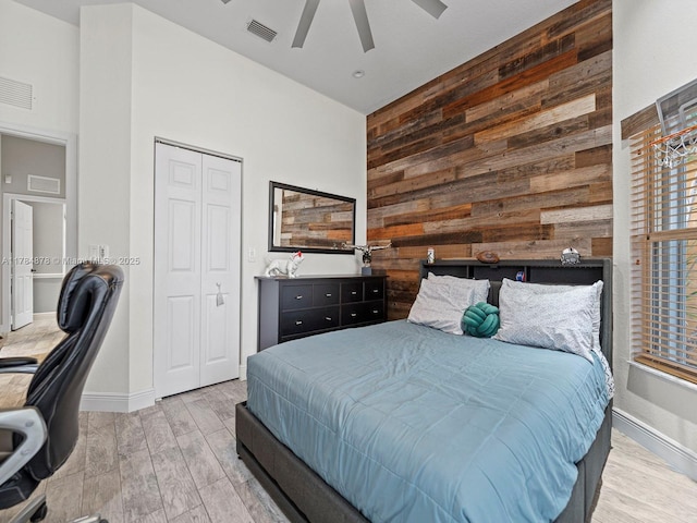 2021 SE 17th Ave, Homestead, FL 33035 - bedroom featuring wooden walls, a high ceiling, wood finished floors, baseboards, and a closet