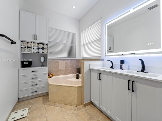 2021 SE 17th Ave, Homestead, FL 33035 - bathroom featuring a tub with jets, double vanity, recessed lighting, and tile patterned flooring