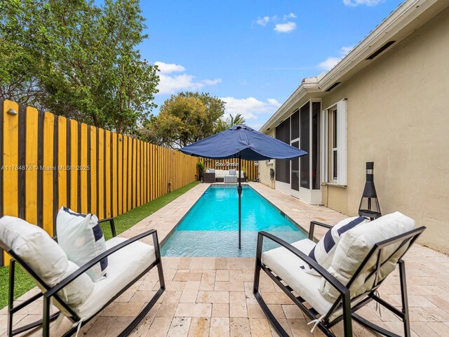 2021 SE 17th Ave, Homestead, FL 33035 - view of pool with a sunroom, outdoor lounge area, a fenced backyard, and a patio area